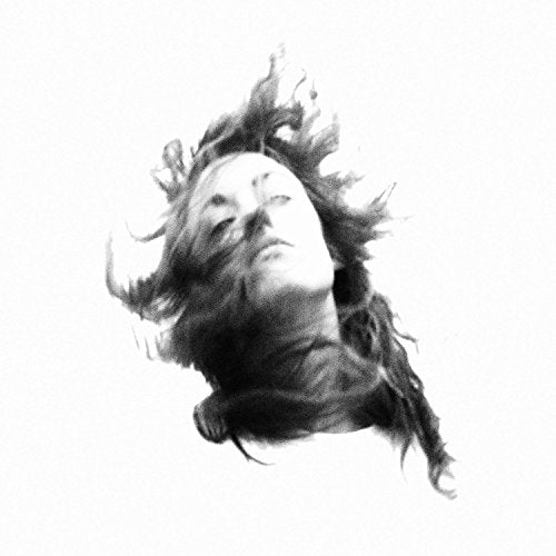 Black and white portrait of a person with flowing hair, eyes closed.