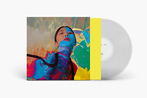Vinyl record with album cover featuring a woman with colorful paint.