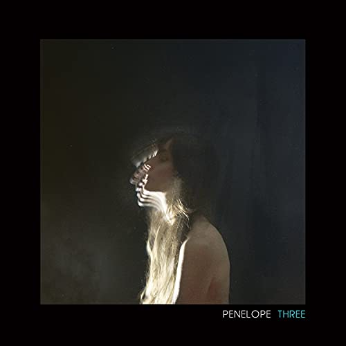 Dark album cover featuring a blurred, long-haired woman in profile.