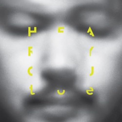 Close-up of a face with yellow, fragmented text spelling "HEAR.