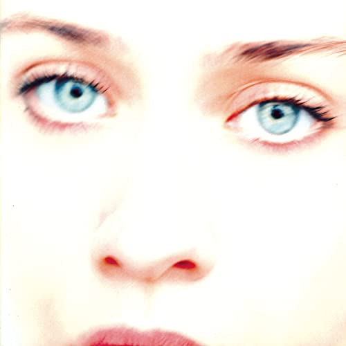 Close-up of a woman’s blue eyes and partial face, album cover.