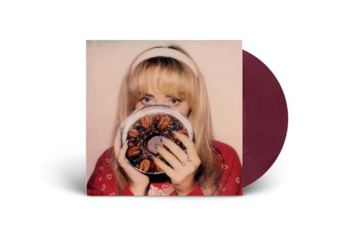 Sabrina Carpenter album cover with a fruitcake and a dark red vinyl record.