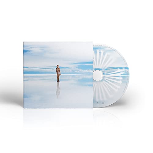 CD cover with a lone figure standing on a reflective salt flat.