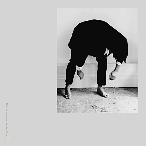 Black and white photo of a person bending over, album cover.