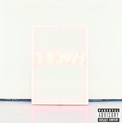 Pink neon sign reading "1975" on a white background, with a warning label.