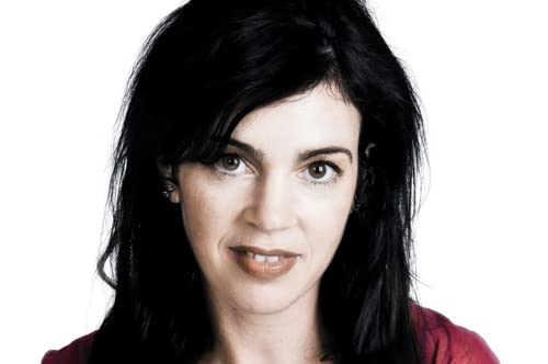 Woman with dark hair and brown eyes looks directly at the viewer.