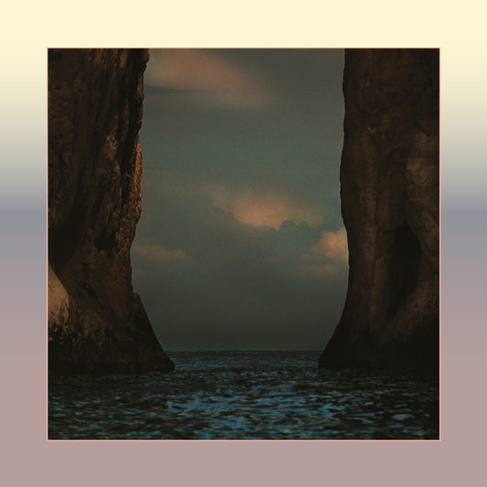 M83 album cover: rocky cliffs framing ocean and cloudy sky.