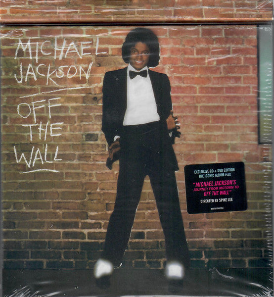 Michael Jackson in a suit leaning against a brick wall, DVD cover.