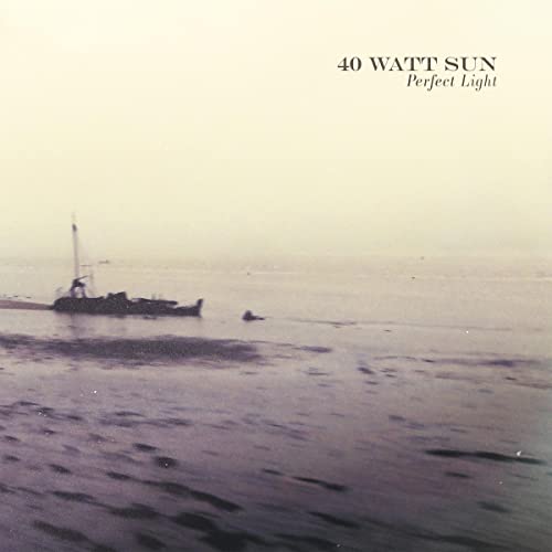 CD cover: foggy seascape with a small boat and distant land.