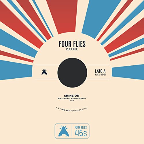 Vinyl record label with red and blue sunburst design, black center hole.