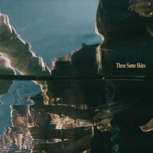 CD cover for Hillsong Worship’s “These Same Skies” with blurred figures.
