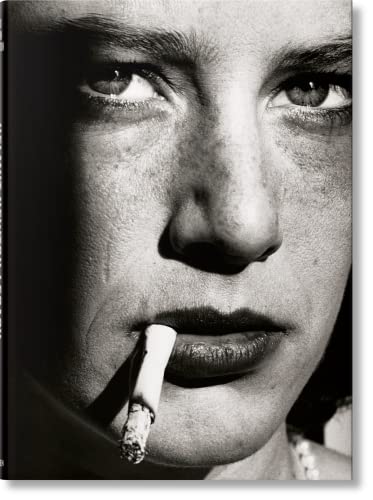 Black and white close-up portrait of a woman with a cigarette in her mouth.