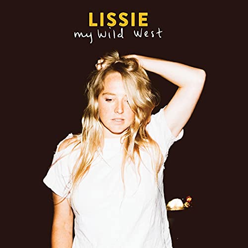 Lissie album cover: woman with blonde hair, looking down, dark background.