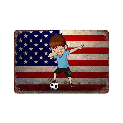 Boy dabbing on a soccer ball in front of an American flag.