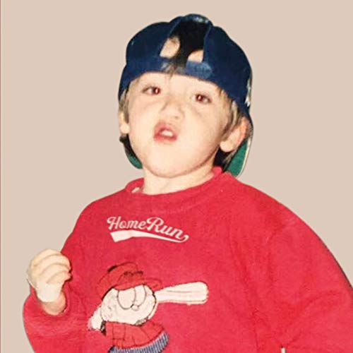 Young boy wearing a baseball cap and red "Homerun" sweater.