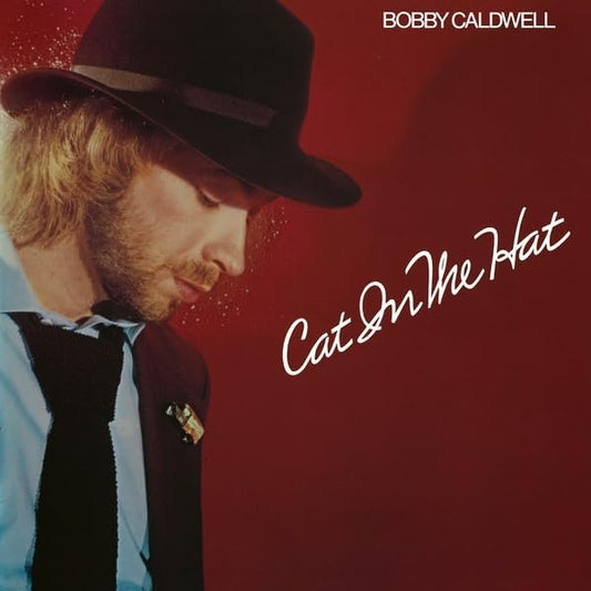 Bobby Caldwell album cover, portrait of a man in a hat, red background.