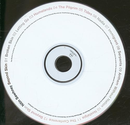 White CD with black text listing song titles from Nitin Sawhney’s “Beyond Skin.”
