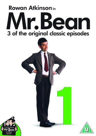 Mr. Bean, Rowan Atkinson, in a suit, standing next to a large green number one.
