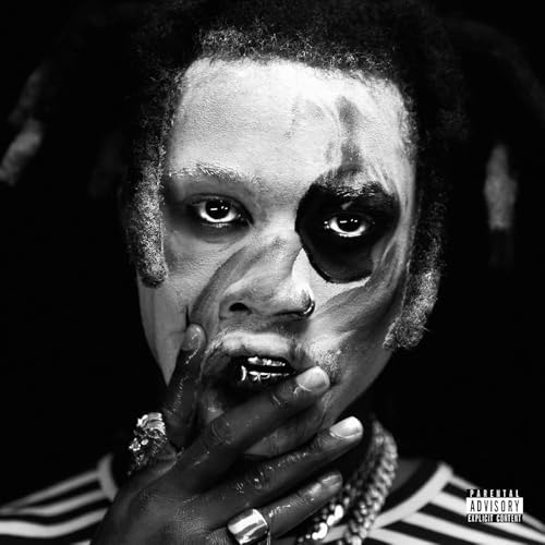 Close-up black and white portrait of Denzel Curry with dramatic makeup.