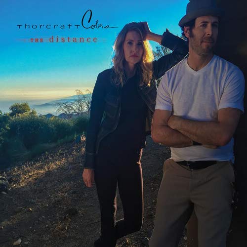 Album cover featuring a man and woman against a hazy landscape.
