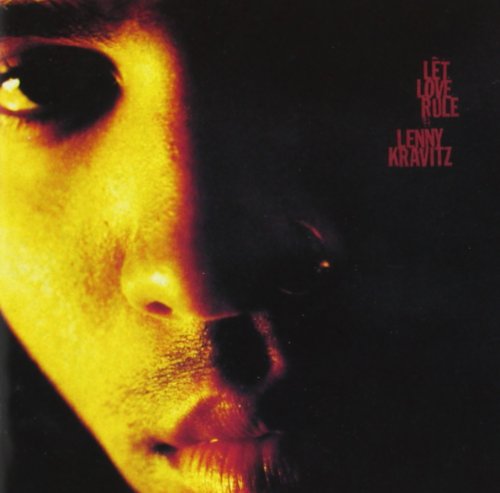 Close-up of Lenny Kravitz’s face with red text: “Let Love Rule.”