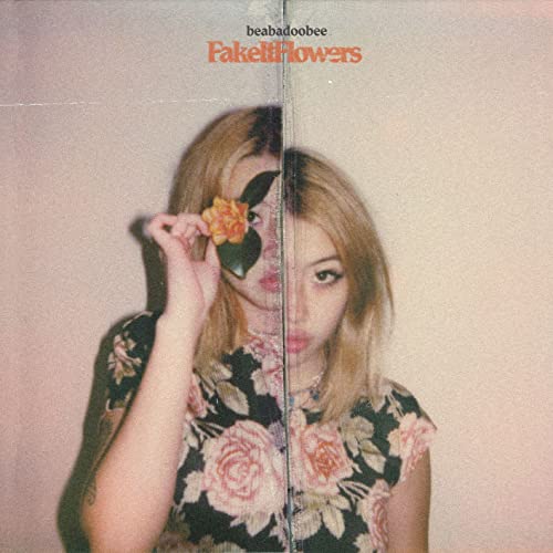 Album cover featuring a split portrait of Beabadoobee holding a flower to her face.