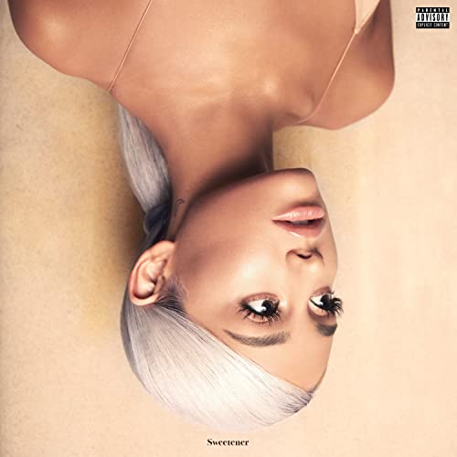 Upside-down portrait of Ariana Grande with platinum blonde hair on a beige background.