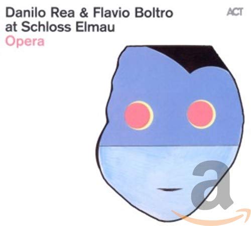 CD cover featuring a blue mask with pink circles and text.