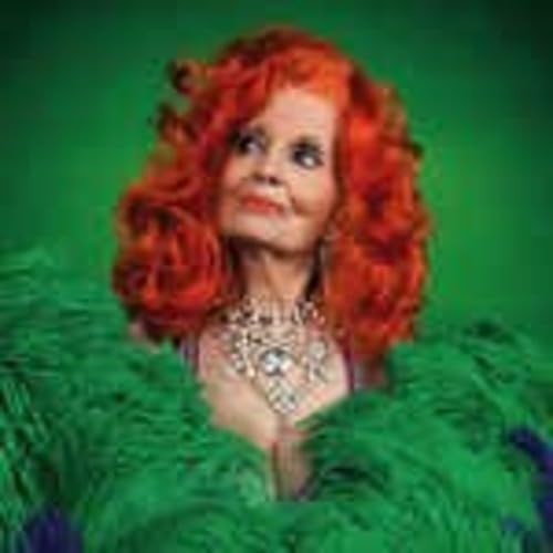 Red-haired Tempest Storm poses with a feathered green boa and jewelry.