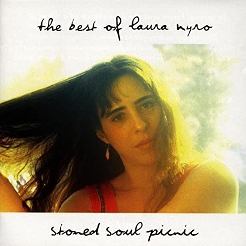 Woman with long dark hair and red top on a brightly lit album cover.