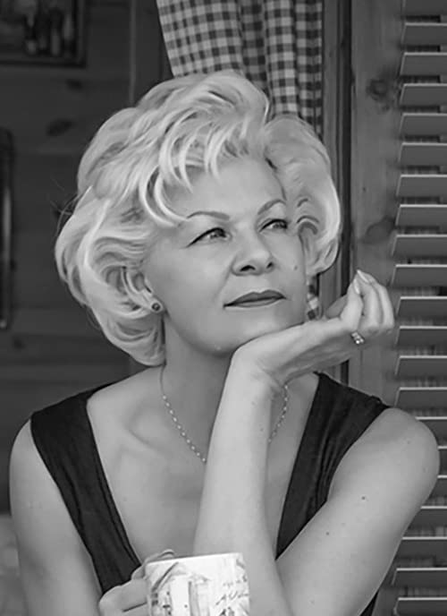 Black and white portrait of a woman with blonde curly hair.