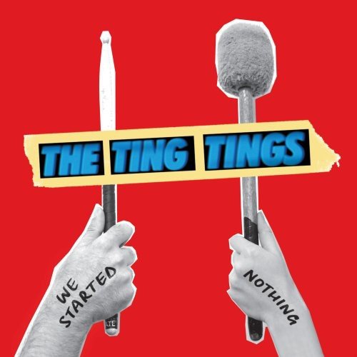 Red album cover for The Ting Tings, featuring hands holding drumsticks.