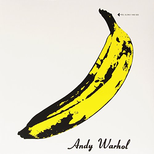 Yellow banana with black spots and peeling effect on white background with Andy Warhol text.