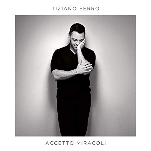 Black and white album cover featuring Tiziano Ferro in a dark polo shirt.