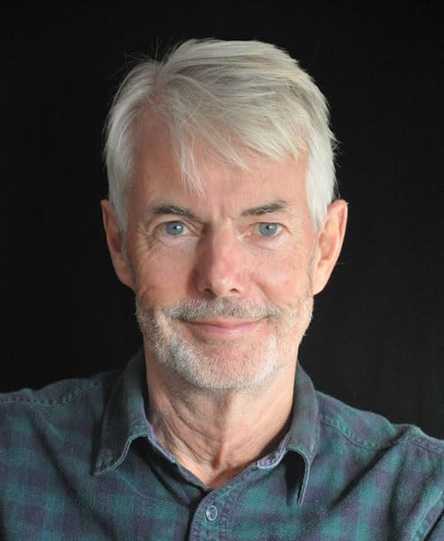 Portrait of an older man with white hair and a gentle smile.