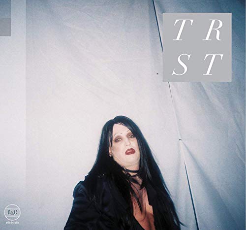CD cover for "Trust" featuring a person with dark hair and makeup.