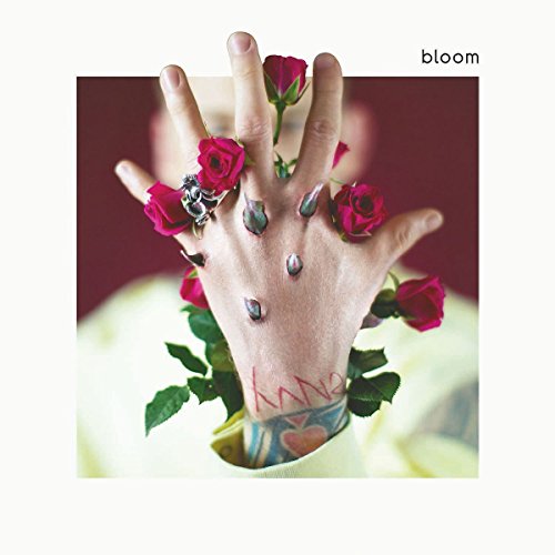 Album cover for MGK’s “bloom” featuring a hand with roses.
