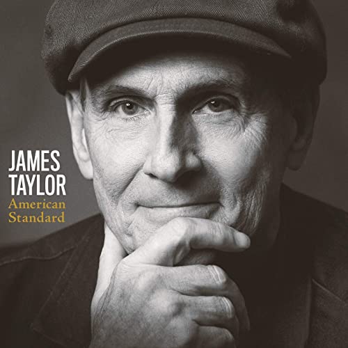 Black and white portrait of James Taylor wearing a cap.