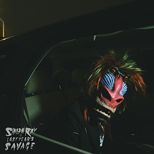 CD cover featuring a baboon wearing a colorful, unsettling mask.