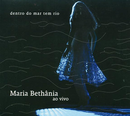 CD cover: Maria Bethânia in blue dress, wavy blue background.