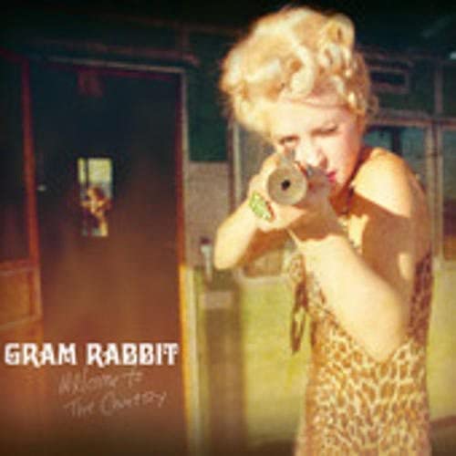 CD cover: woman with curly blonde hair aiming a vintage camera.