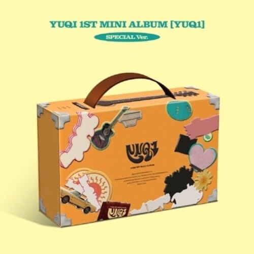 Orange suitcase-style album packaging with a brown handle and colorful collage graphics.