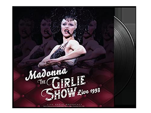 Madonna in costume with dancers, vinyl record beside album cover.