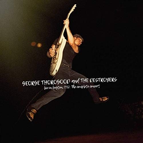 Guitarist George Thorogood mid-jump on stage, album cover for live concert recording.