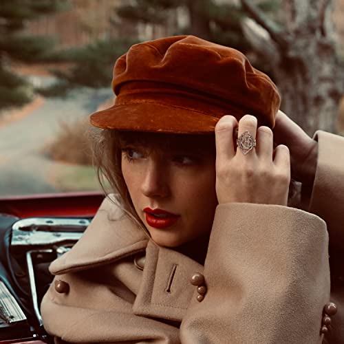 Taylor Swift wearing a red cap and ornate ring, looking left.