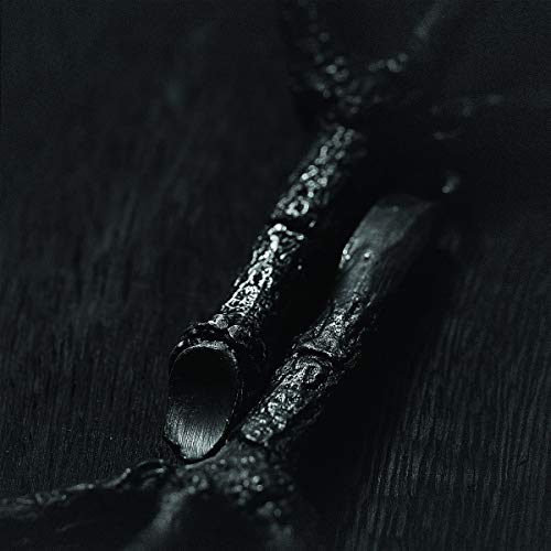 Dark, textured image of what appears to be charred wood or branches.