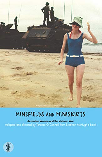 Woman in swimsuit walks on beach with tanks and soldiers visible.