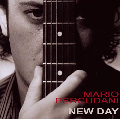 Close-up of a man with a guitar, album cover for “New Day”.