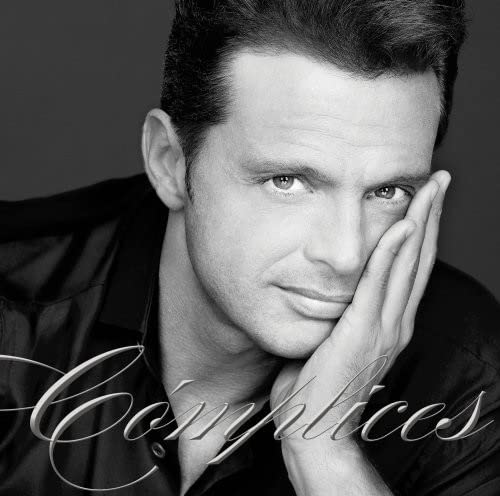 Black and white portrait of Luis Miguel with the album title "Complices".