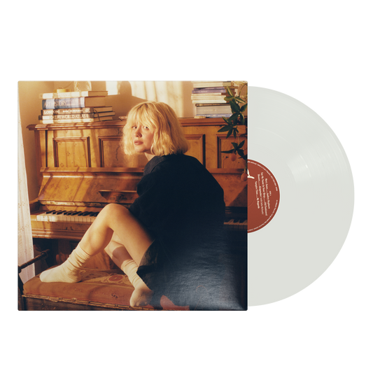 Maisie Peters album cover featuring a woman with blonde hair and a piano.